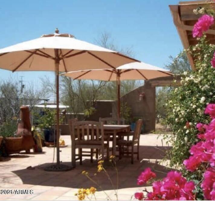 6017 East Rancho Del Oro Drive Cave Creek, AZ 85331 - Photo 5 of 28 a view of a tables and chairs under an umbrella