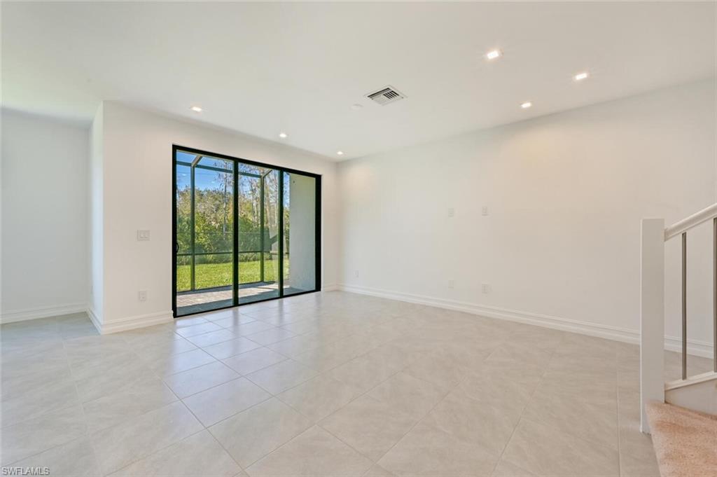 7611 Morgan Way Naples, FL 34119 - Photo 3 of 26 a view of an empty room with glass door