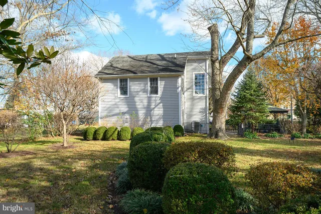 a bathroom with a toilet sink vanity tub and mirror