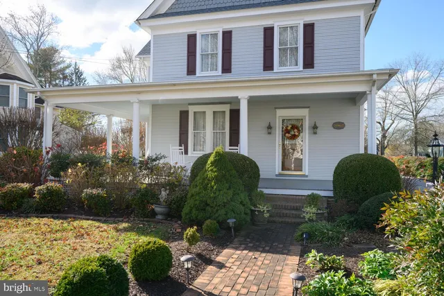 a kitchen with stainless steel appliances granite countertop a sink dishwasher stove and refrigerator with wooden cabinets