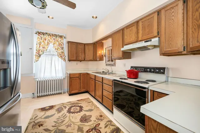 a spacious bathroom with a toilet a sink and a mirror