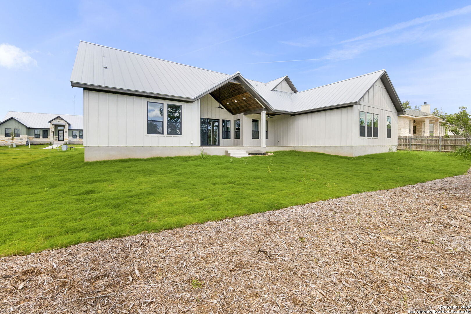 31 Peace Pipe Wimberley, TX 78676 - Photo 2 of 11 a front view of a house with a yard and garage