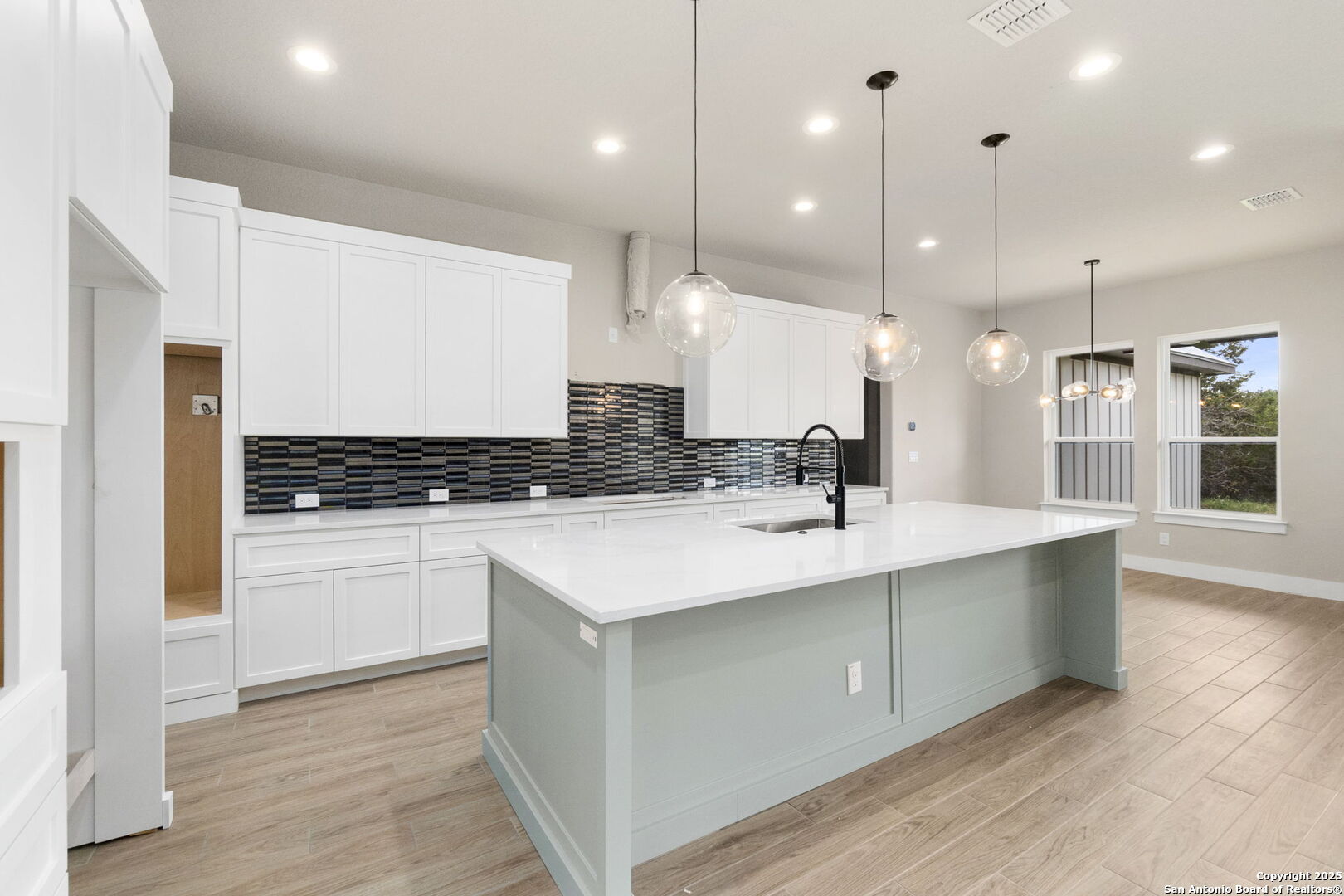 31 Peace Pipe Wimberley, TX 78676 - Photo 8 of 11 a kitchen with a sink stainless steel appliances and wooden floor