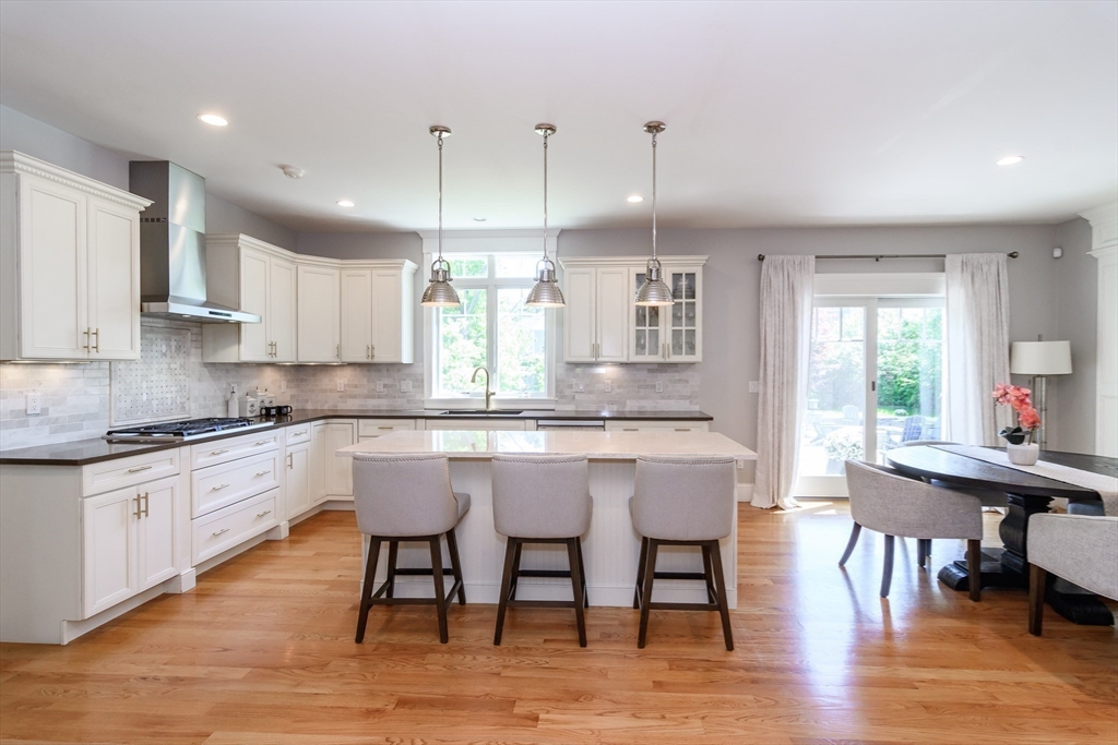2 Hunters Lane Natick, MA 01760 - Photo 6 of 40 a kitchen with stainless steel appliances granite countertop a kitchen island hardwood floor sink and stove