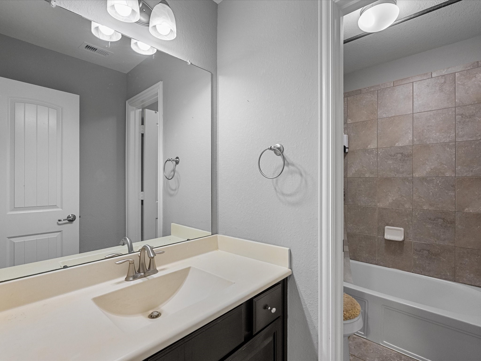 5323 Savannah Bend Lane Rosharon, TX 77583 - Photo 31 of 46 a bathroom with a sink vanity granite tub shower and a mirror
