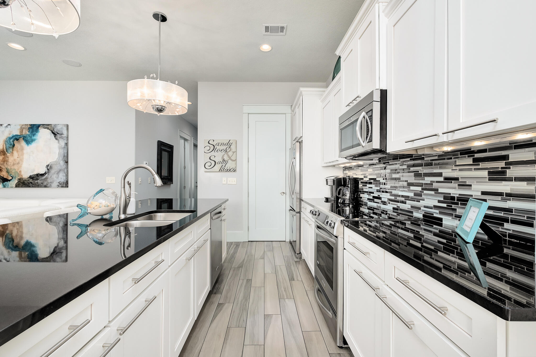 1959 Baytowne Loop Miramar Beach, FL 32550 - Photo 9 of 33 a kitchen with stainless steel appliances granite countertop a sink a stove and cabinets
