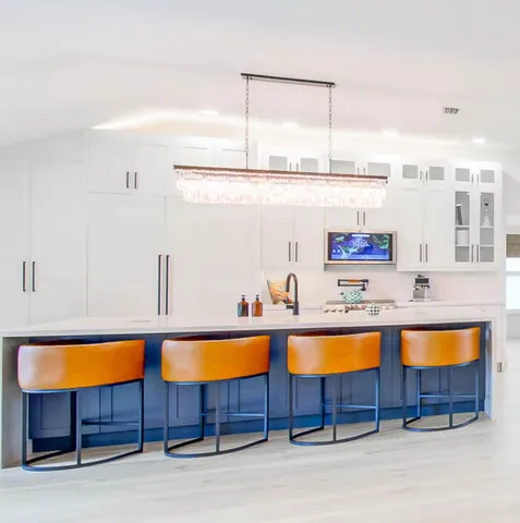 a kitchen with a sink a counter and chairs