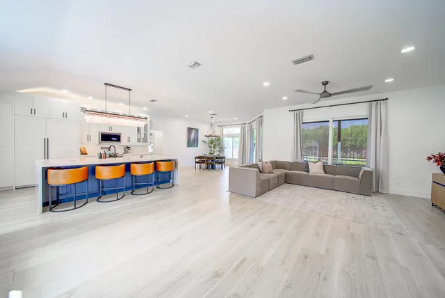a living room with furniture and kitchen view