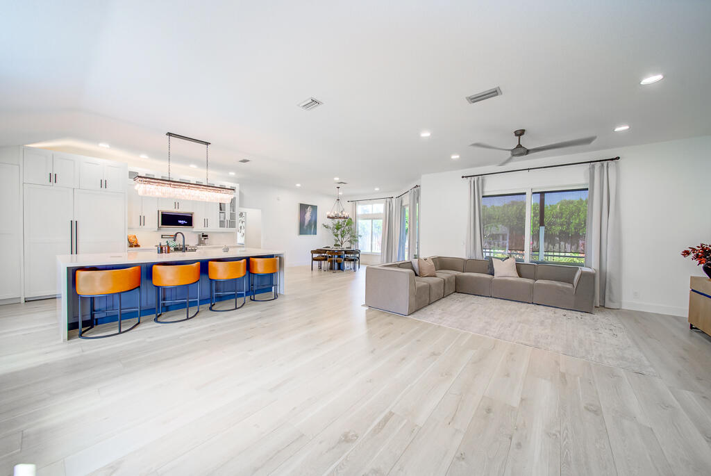 1853 Shower Tree Way Wellington, FL 33414 - Photo 11 of 31 a living room with furniture and kitchen view