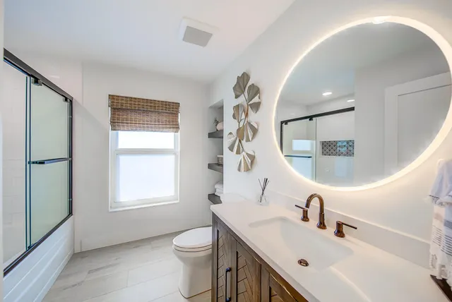 a bed room with a bed and a ceiling fan