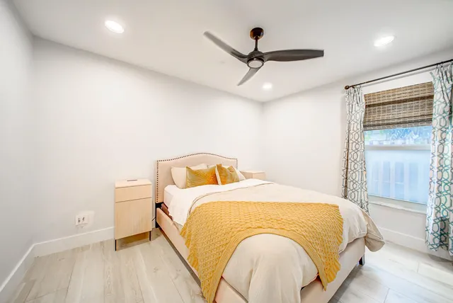 a backyard of a house with plants and wooden fence