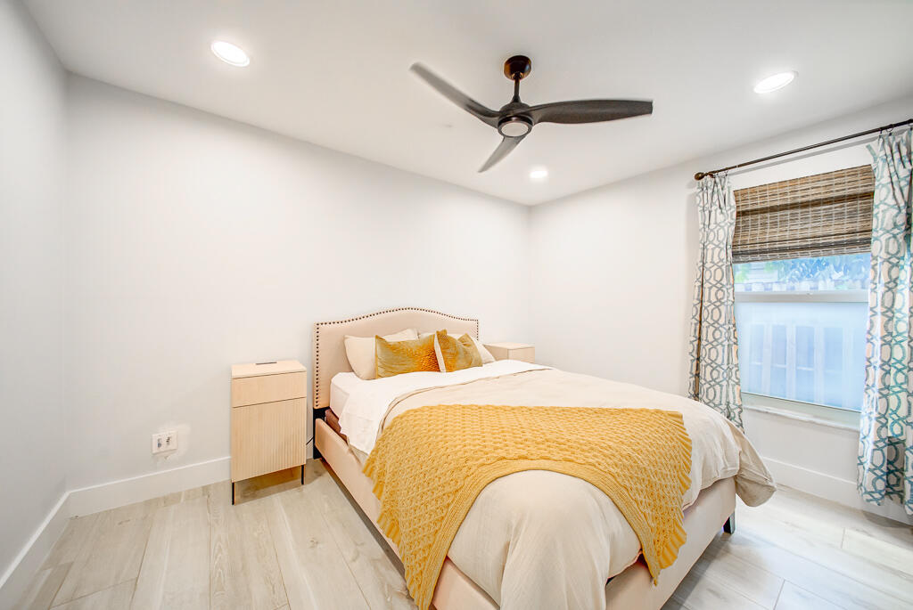 1853 Shower Tree Way Wellington, FL 33414 - Photo 25 of 31 a bed room with a bed and a ceiling fan