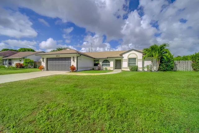 a front view of house with yard and green space