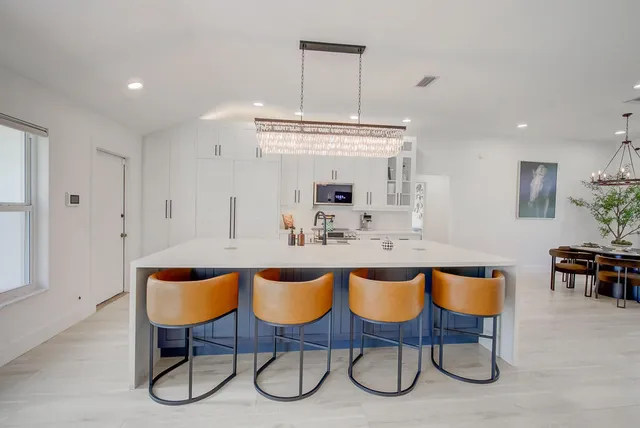 a dining hall with a dining table and chairs