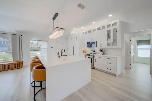 a view of living room with furniture and wooden floor
