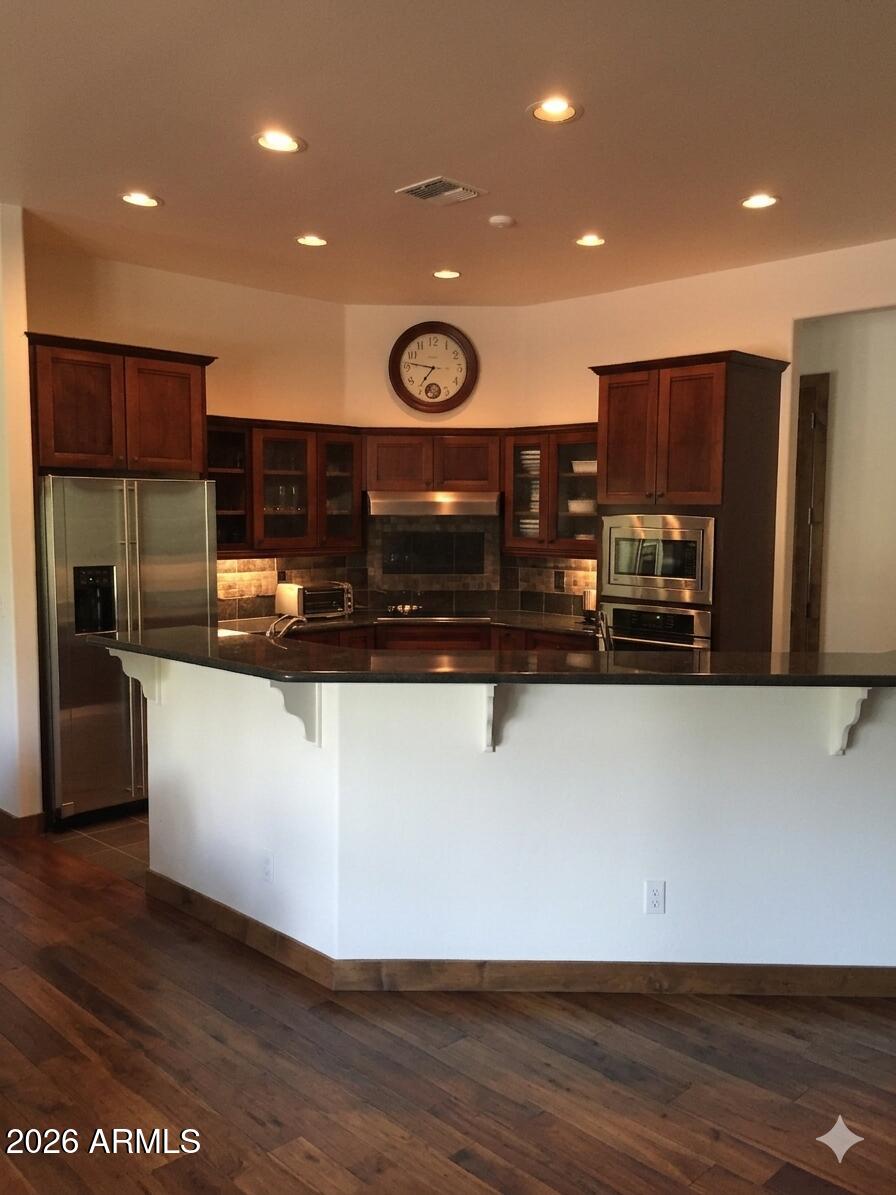 243 Oak Drive Payson, AZ 85541 - Photo 11 of 24 a view of kitchen with stainless steel appliances granite countertop a stove a refrigerator and a sink with wooden floor