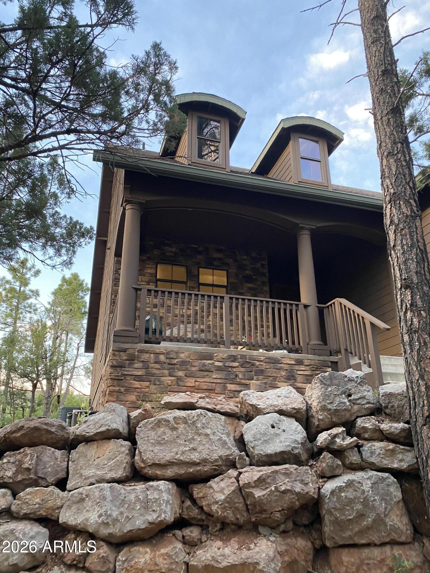 243 Oak Drive Payson, AZ 85541 - Photo 5 of 24 a view of a brick house with large windows