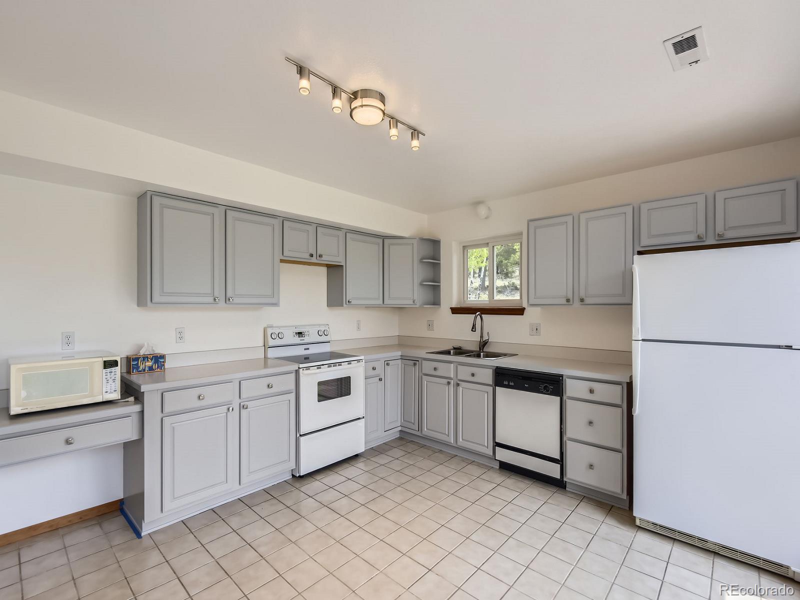 52 Branding Iron Lane Bailey, CO 80421 - Photo 12 of 29 a kitchen with sink and white cabinets