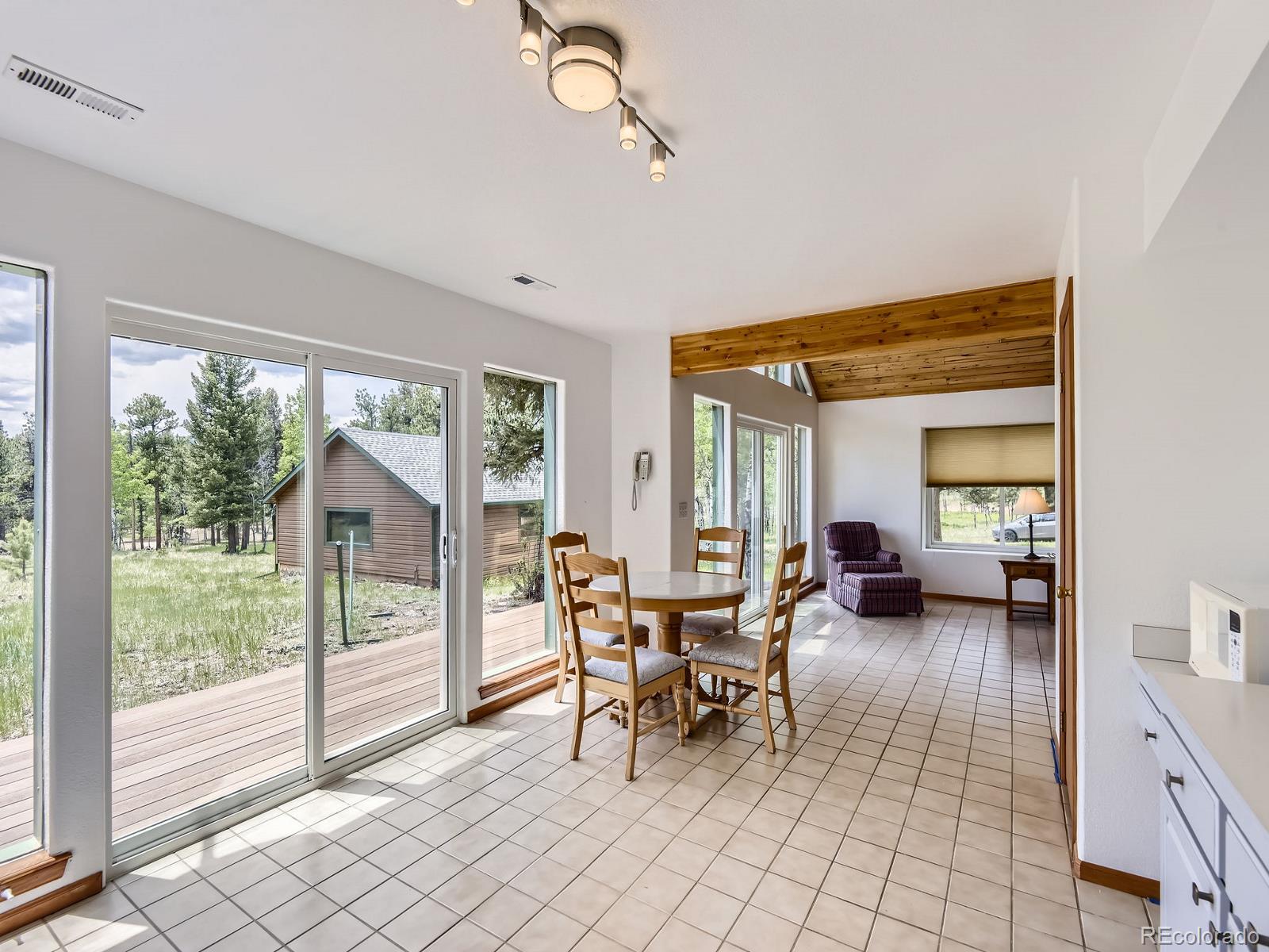 52 Branding Iron Lane Bailey, CO 80421 - Photo 14 of 29 a living room with furniture and a floor to ceiling window