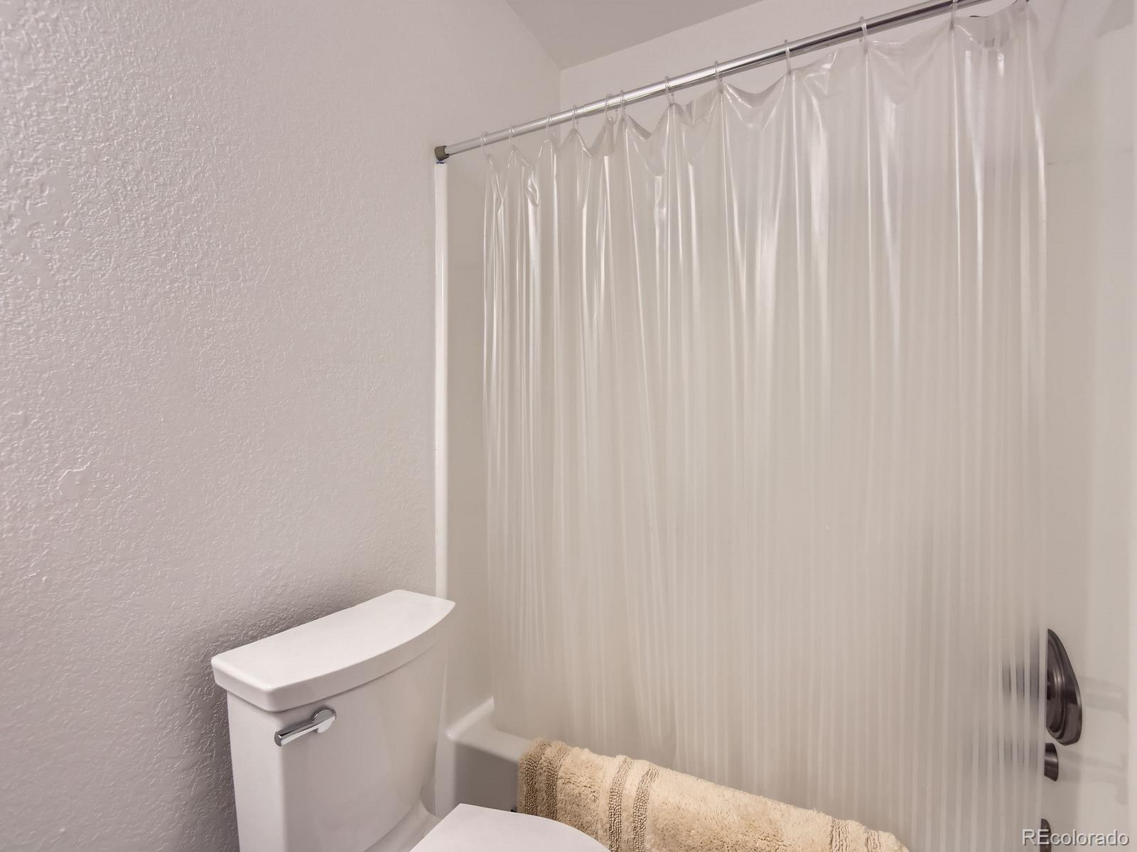 52 Branding Iron Lane Bailey, CO 80421 - Photo 16 of 29 a white toilet sitting next to a shower