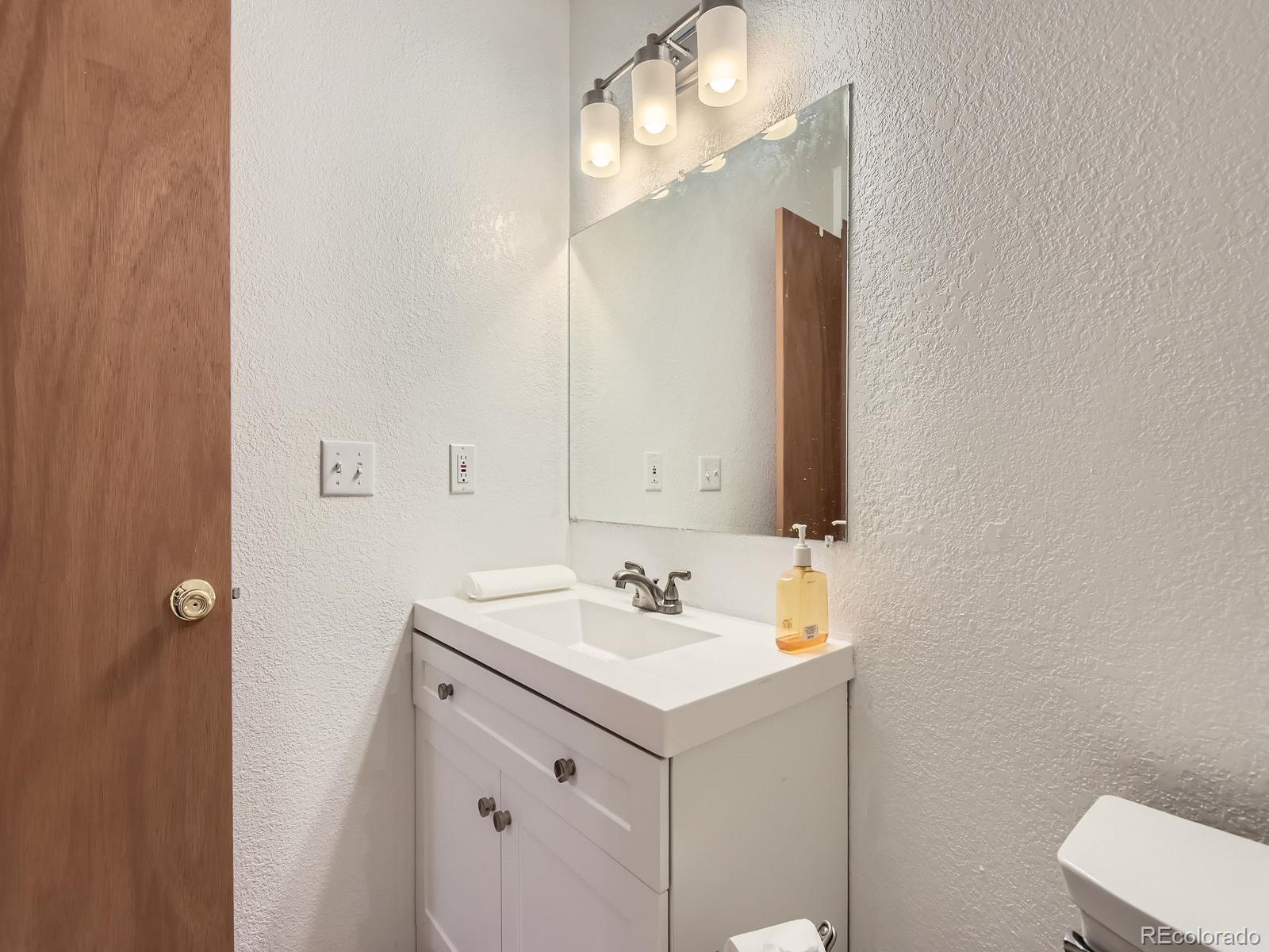 52 Branding Iron Lane Bailey, CO 80421 - Photo 17 of 29 a bathroom with a sink and a mirror