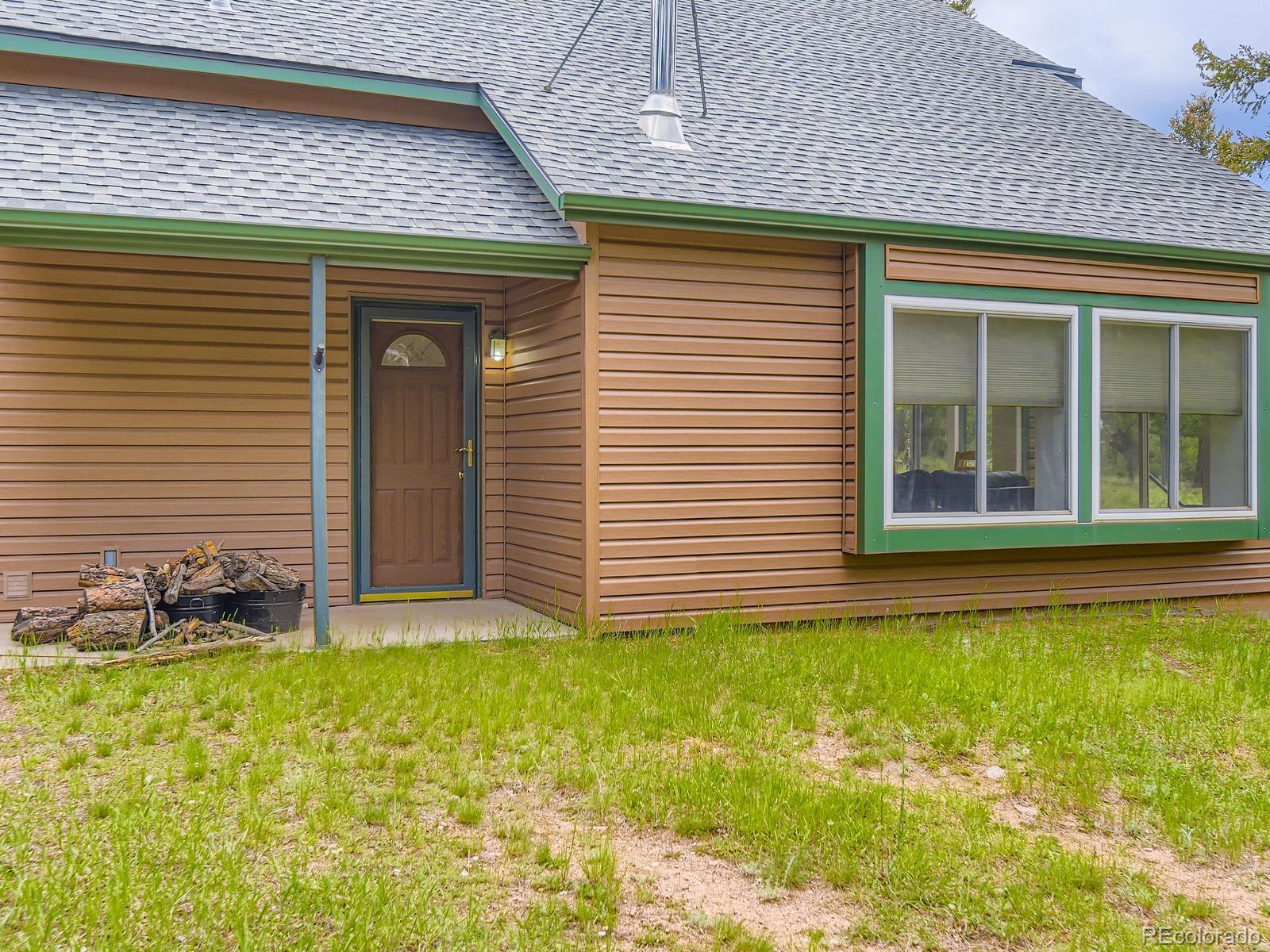 52 Branding Iron Lane Bailey, CO 80421 - Photo 3 of 29 a front view of a house with a yard