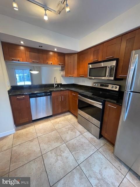 9646 Hingston Downs Columbia, MD 21046 - Photo 12 of 17 a kitchen with stainless steel appliances granite countertop a stove a sink and a microwave