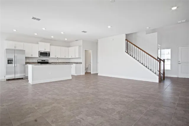 a view of a kitchen with a sink cabinets and a large window
