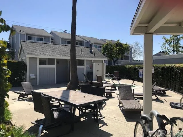 a view of a patio with table and chairs and potted plants