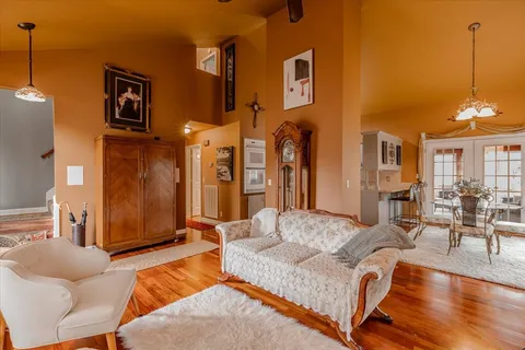 a living room with furniture and a chandelier