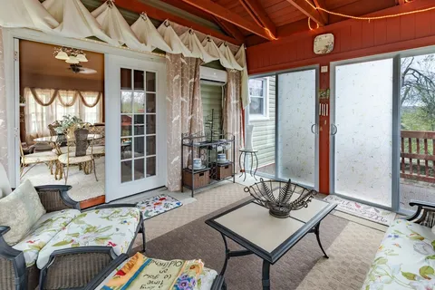 a living room with furniture and large windows