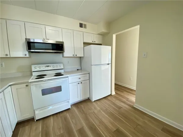 a kitchen with a white cabinets and white appliances