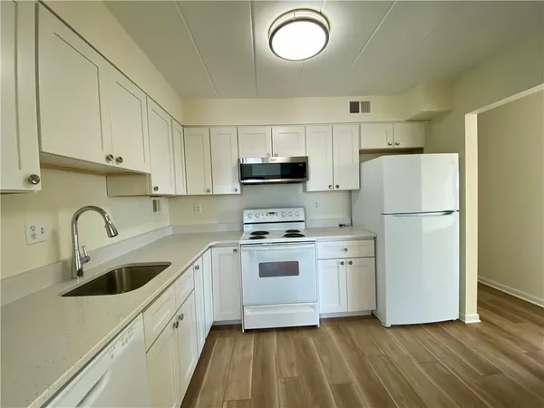 a kitchen with a sink cabinets and stainless steel appliances