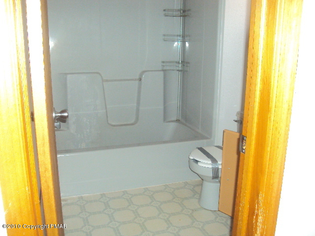 28 Cherry Ridge Road Layton, NJ 07851 - Photo 4 of 11 a bathroom with a granite countertop toilet and a shower