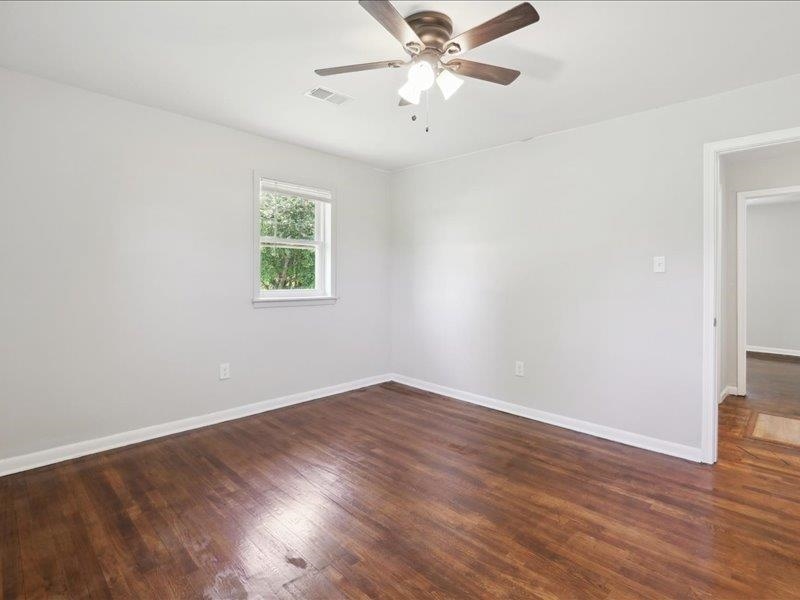 2725 Porter Road Mason, TN 38049 - Photo 16 of 33 an empty room with wooden floor fan and windows