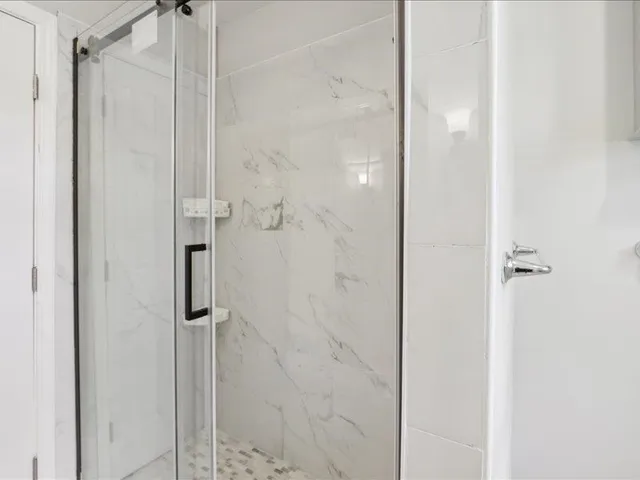 a bathroom with a glass shower door