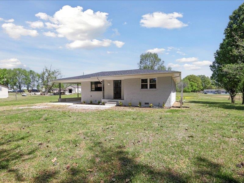 2725 Porter Road Mason, TN 38049 - Photo 3 of 33 a front view of a house with a yard and garage