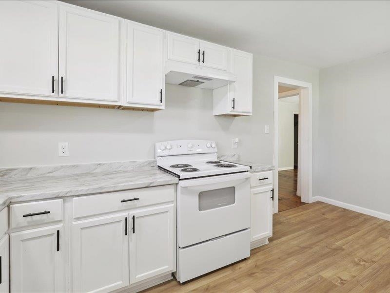 2725 Porter Road Mason, TN 38049 - Photo 33 of 33 a kitchen with granite countertop white cabinets and white appliances