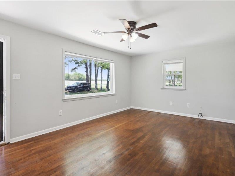 2725 Porter Road Mason, TN 38049 - Photo 5 of 33 a view of an empty room with wooden floor and a window