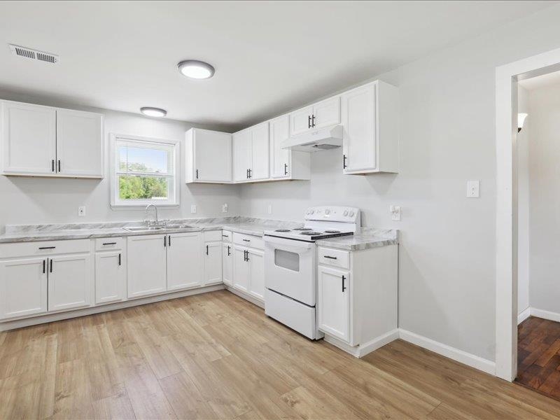 2725 Porter Road Mason, TN 38049 - Photo 10 of 33 a kitchen with granite countertop white cabinets and white appliances