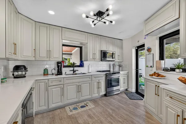 a kitchen with a stove a sink and a refrigerator