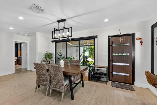a living room with furniture a flat screen tv and kitchen view