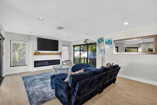 a living room with furniture a rug and a large window