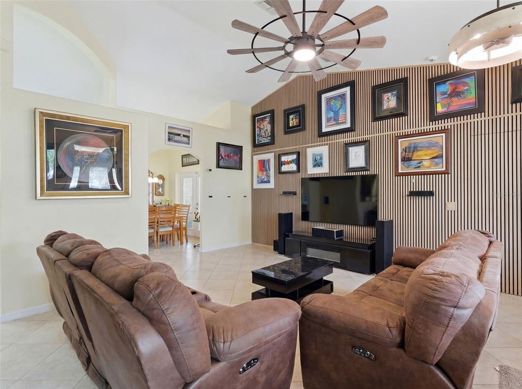 3510 Hunters Trail Circle Eustis, FL 32726 - Photo 14 of 26 a living room with furniture a flat screen tv and a bookshelf