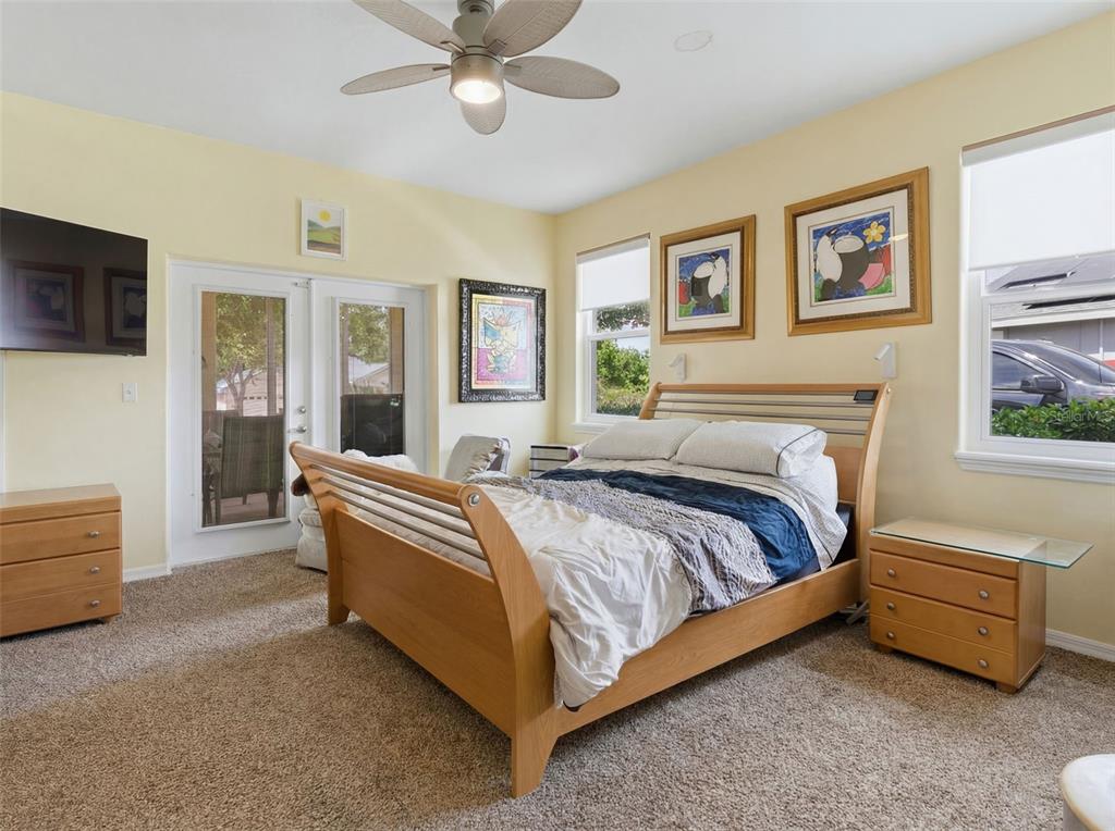 3510 Hunters Trail Circle Eustis, FL 32726 - Photo 16 of 26 a spacious bedroom with a bed and ceiling fan