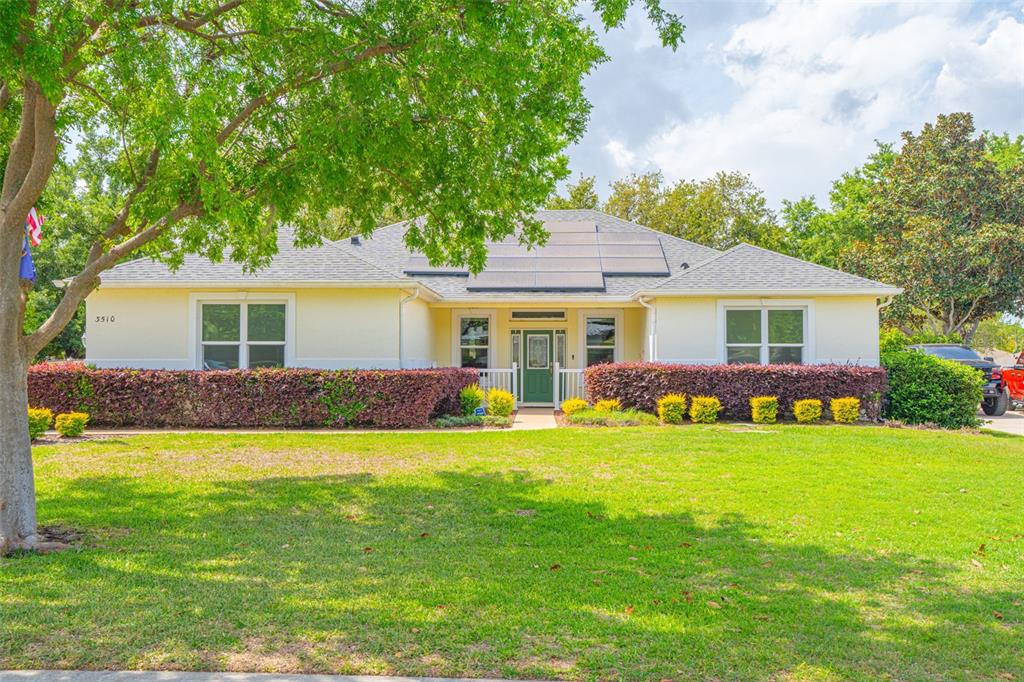 3510 Hunters Trail Circle Eustis, FL 32726 - Photo 2 of 26 a front view of a house with a garden and porch