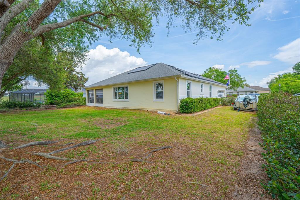 3510 Hunters Trail Circle Eustis, FL 32726 - Photo 24 of 26 a yellow and red house sitting in middle of the grass