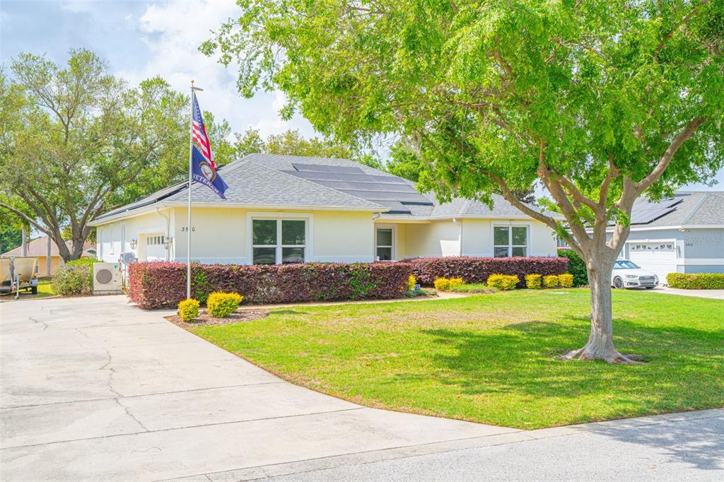 3510 Hunters Trail Circle Eustis, FL 32726 - Photo 3 of 26 a front view of a house with a yard table and chairs