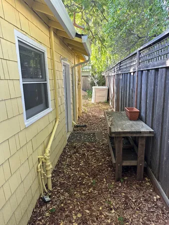 a backyard of a house with table and chairs