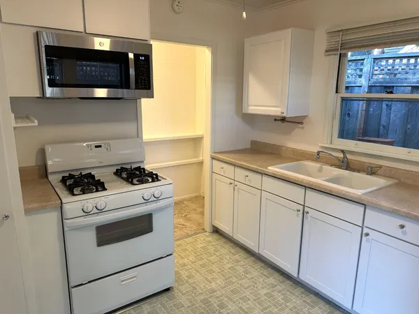 a kitchen with a stove and a sink